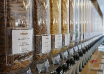 clear glass jars on brown wooden shelf
