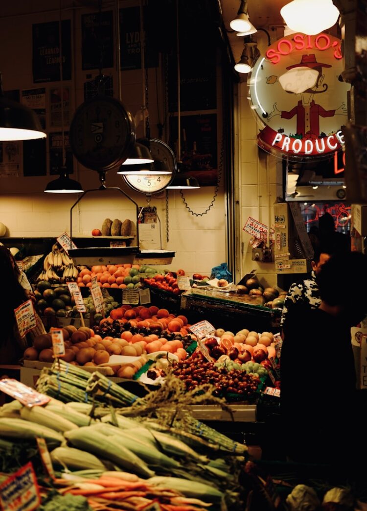 A fruit stand glows with neon signs.