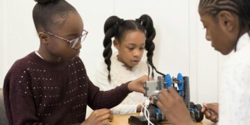 two girls are working on a project together