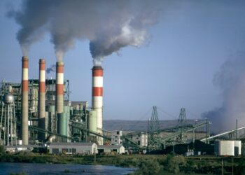 a factory with smoke coming out of it's stacks