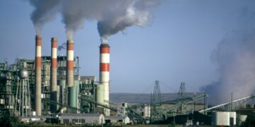 a factory with smoke coming out of it's stacks