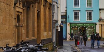 a bunch of bikes parked on the side of a street