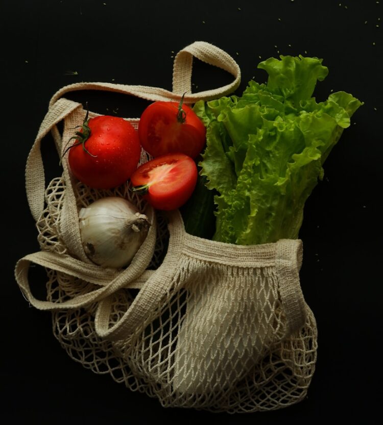 a bag filled with lettuce and tomatoes
