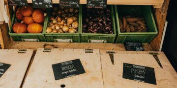 green and brown fruit on brown wooden crate