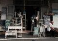 two men sitting in front of table beside assorted wall decors store