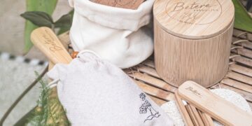 a bamboo table topped with wooden utensils and a bag
