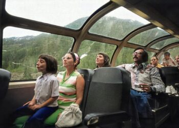 a group of people sitting around a car window