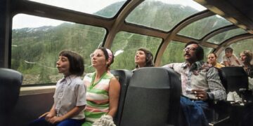 a group of people sitting around a car window