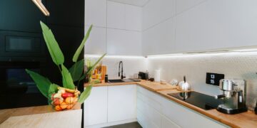 A kitchen with a plant in the middle of the counter