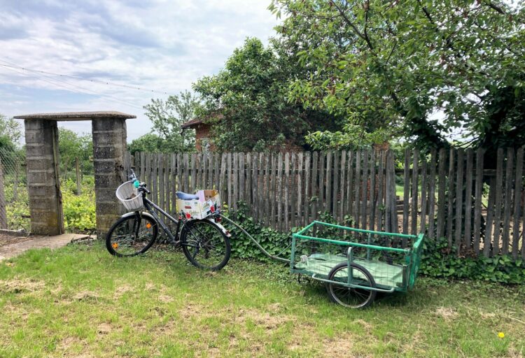 a bike parked next to a wooden fence