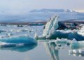 a group of icebergs floating on top of a body of water