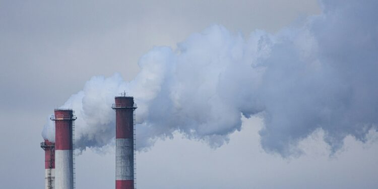 smoke billows from the stacks of smoke stacks