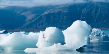 a large iceberg floating on top of a body of water