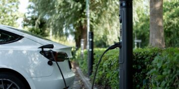 An electric car is charging at a station.