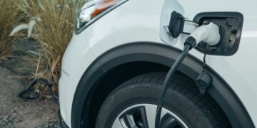 Close-up of an electric vehicle charging at a station, promoting clean energy.